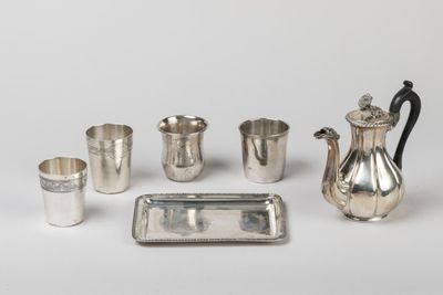 an assortment of silverware including a teapot, cups, tray, and tray