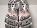 the soles of a pair of running shoes on a white surface