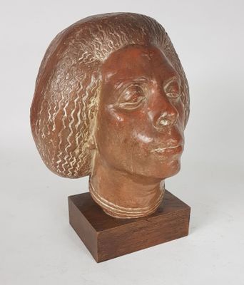 an image of a sculpture of a woman ' s head on a wooden stand