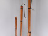 three copper colored pipes sitting next to each other on a white surface