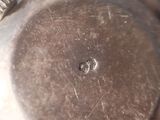 a close up of a metal object with a hole in it