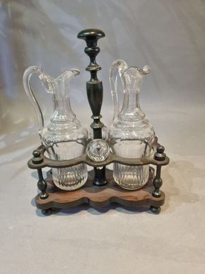 three glass vases and a candle holder on a table