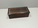 a small wooden box sitting on top of a white table