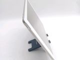 a white tablet computer sitting on a stand on a table