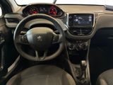 the interior of a small car with a steering wheel and dashboard
