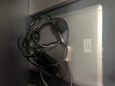 a laptop and headphones sitting on a shelf next to a mouse