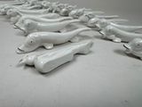 a lot of white dog figurines sitting on the floor