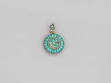 un pendentif en émail doré et turquoise, de forme circulaire