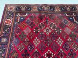 an oriental rug on the floor with a blue background