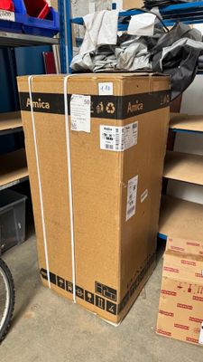 a box that is sitting on the floor next to a bike