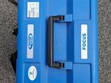 a blue tool box with a blue handle on the ground