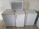 three refrigerators and a microwave sitting on top of each other