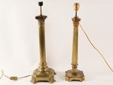 pair of brass table lamps with a black shade on each of them