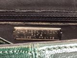 a close up of a green purse with a name tag