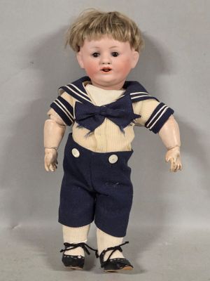 a small doll that is wearing a sailor outfit