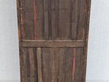 an old wooden cabinet with a red stripe painted on the door
