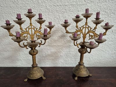 pair of antique brass candelabs with pink candles