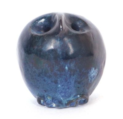 a blue vase that is sitting on a white surface