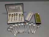 a lot of silver spoons in a box on a table