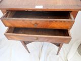 a small wooden desk with three drawers on it