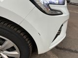 a close up of a white car parked in a parking lot