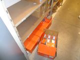 an orange box in the middle of a shelf in a store