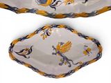 a white bowl with yellow and blue designs on it