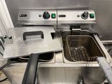 two deep fryers that are sitting in a kitchen