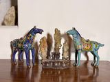 trois figurines de chevaux posées sur une table en bois