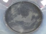 a close up of a plastic container with a black lid