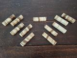 six pieces of wood sitting on top of a wooden table