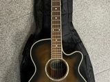 acoustic guitar with hard case on carpeted floor in room