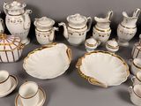many different types of porcelain dishes and cups on the table