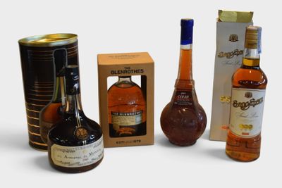 several different types of liquor bottles and cans on a white surface