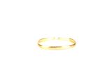 a close up of a gold ring on a white surface