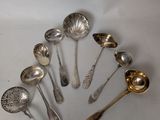 a lot of silver spoons and spoon spoons on the table