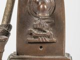 a silver statue of a baseball player holding a bat