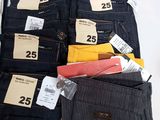 several pairs of men ' s jeans with price tags on them