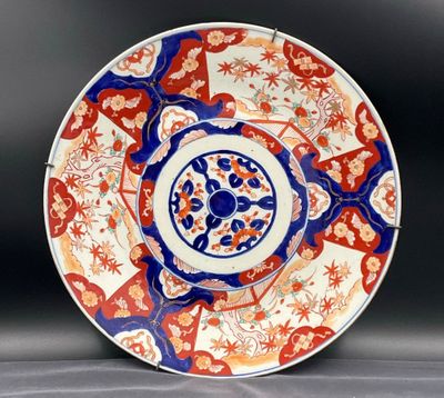 a red and blue plate with a circular design on it