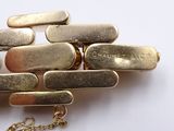 a close up of a bunch of gold bars on a chain
