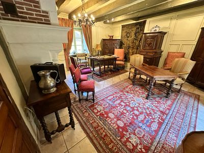 a living room with a fireplace and a rug on the floor