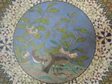 a picture of a plate with a bird and flowers on it