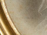 an image of a close up of a gold frame with a picture on it