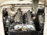 a close up of a car engine with the hood open