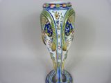 a vase that is sitting on a white surface