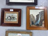 four framed pictures on the wall of a room