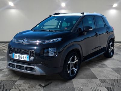 a black citrole is parked in a room with a checkered floor
