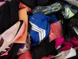 a suitcase full of clothes and shoes on the floor