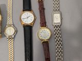 several different types of watches are displayed on a table
