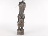 an old wooden statue of a woman with a bird on top of her head